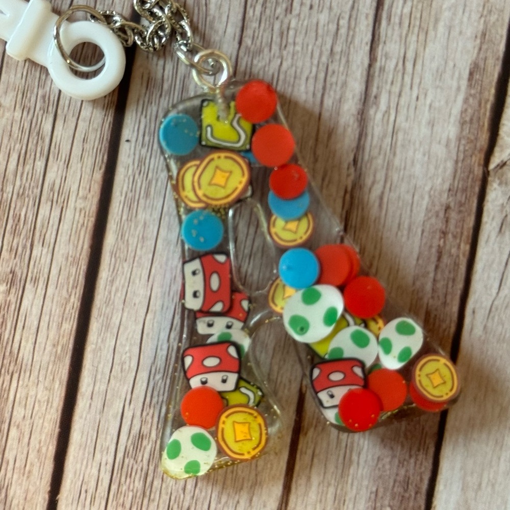 Letter A bag charm with video game inspired charms newly made.